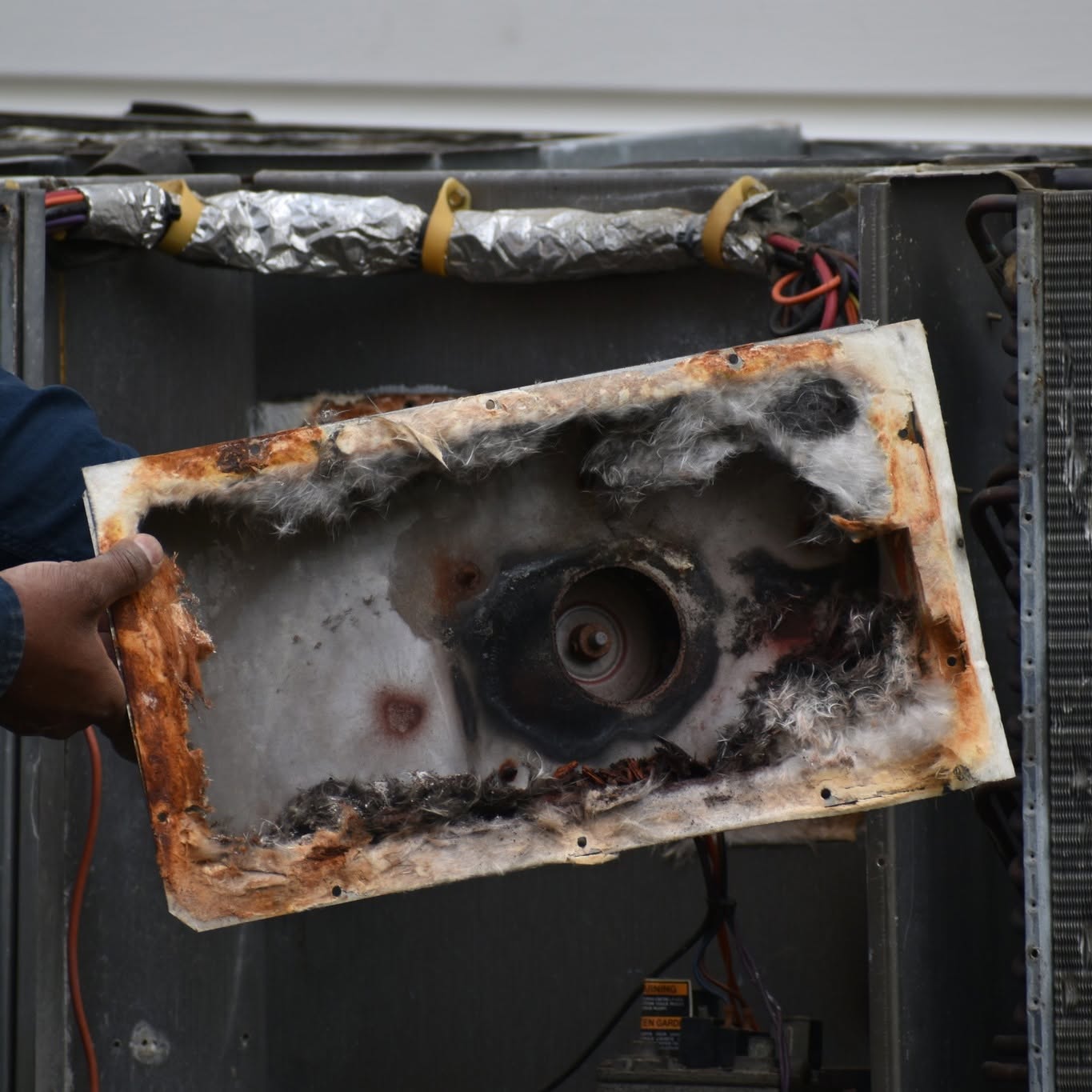 Corroded furnace access panel found during a repair call