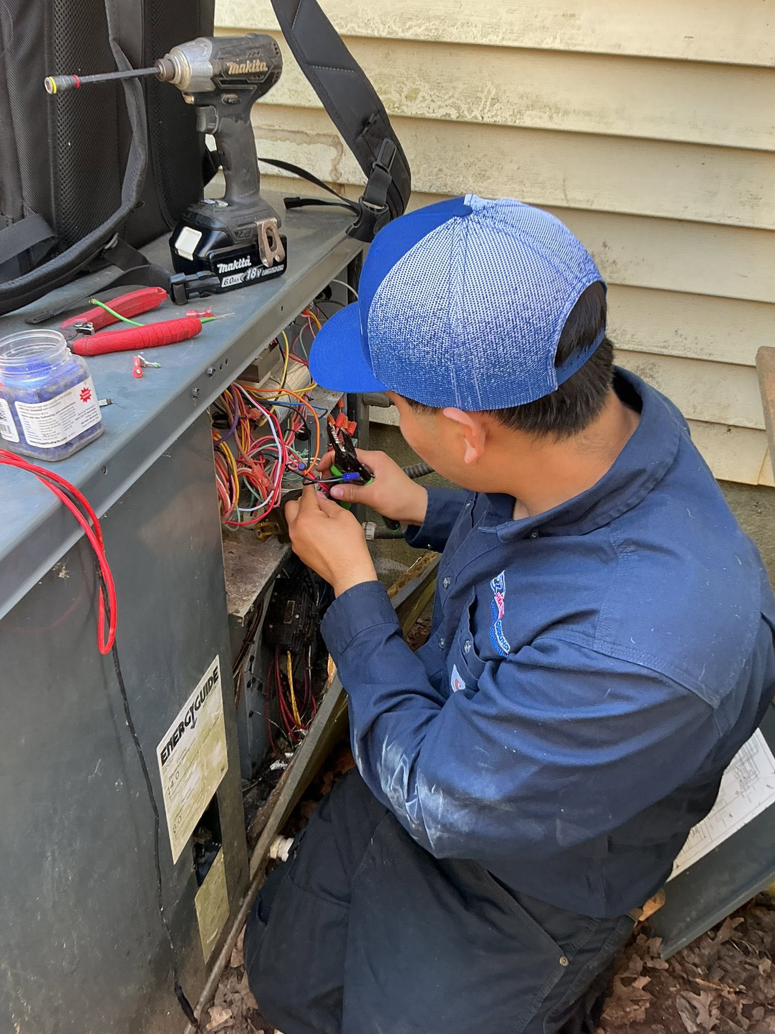 Technician repairing furnace control board wiring