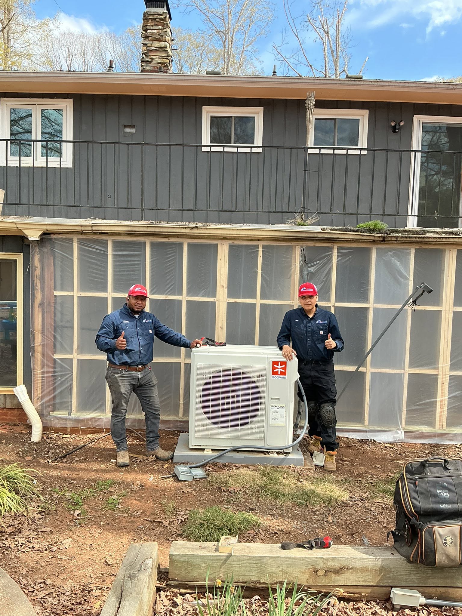 PZ technicians beside a newly installed ductless mini-split system