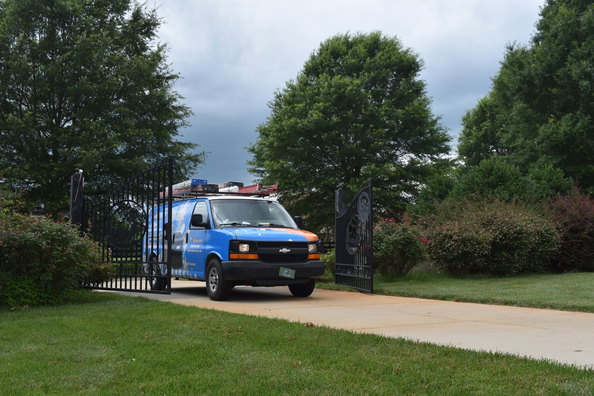 PZ Heating & Cooling service van arriving at a residential job site