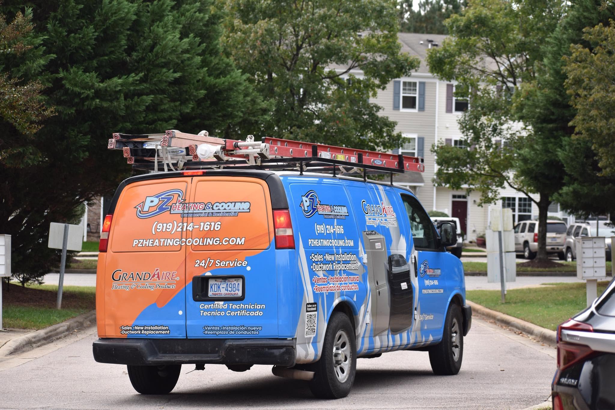 PZ Heating & Cooling service van parked on a residential street
