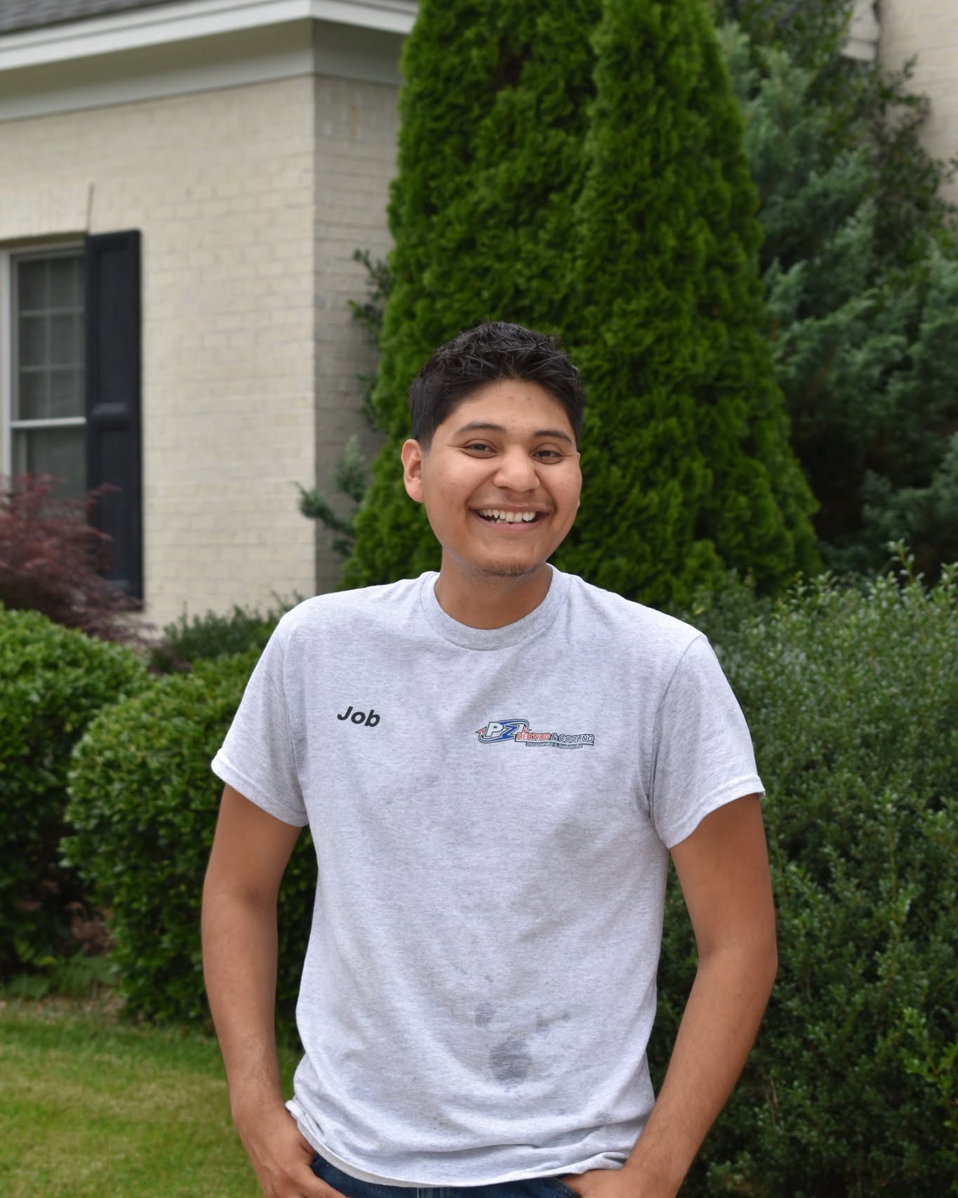PZ Heating & Cooling technician Job smiling on a residential job site